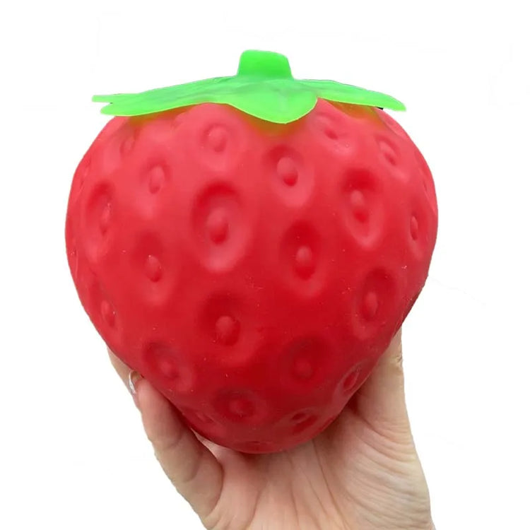 Squishy fraise géante anti-stress de 14 cm tenue dans une main